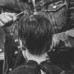 person cutting boy's hair