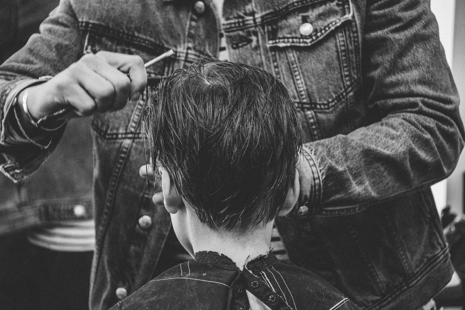 person cutting boy's hair